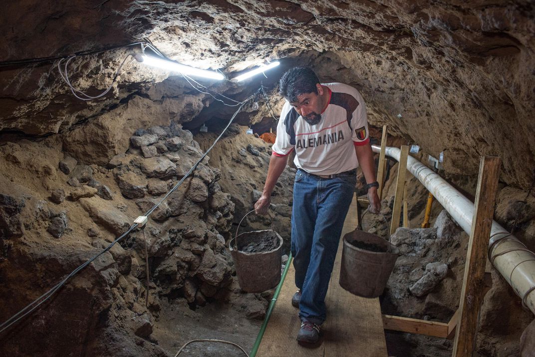 Arbetare som tar bort smuts i en tunnel under Pyramid of the Feathered Orm, Teotihuacán. Upphovsman: Janet Jarman.
