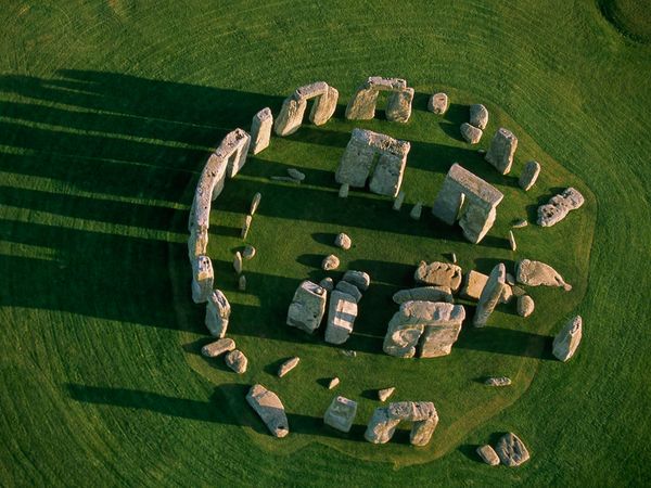 At ground level, the ruins of Stonehenge appear somewhat random and chaotic, but a view from the air reveals the monument's circular order. The site started out modestly around 3100 B.C. as a wide ring of wood posts surrounded by a ditch and bank. The familiar enormous rock slabs, some brought from hundreds of miles away, were added to the interior over a period of about 1,500 years. © Photographed by Joe McNally Sygma