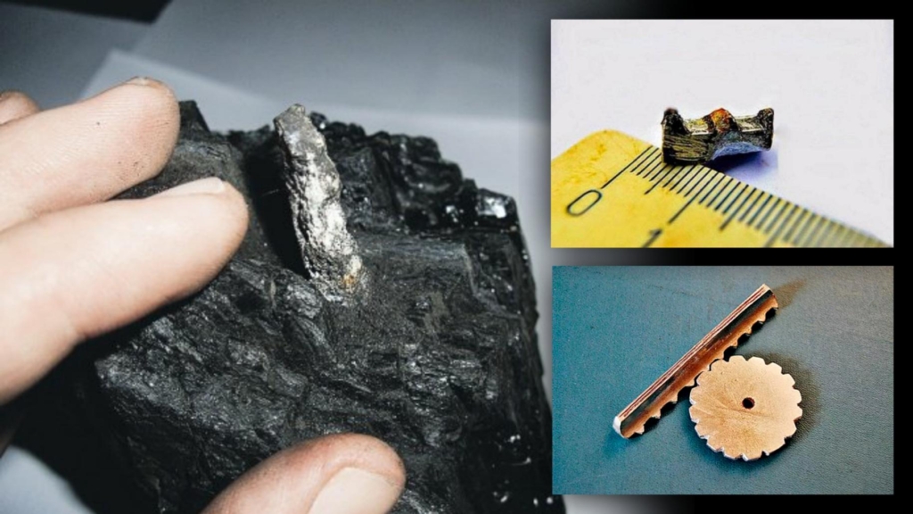 O trilho de aparência metálica pressionou o carvão.
