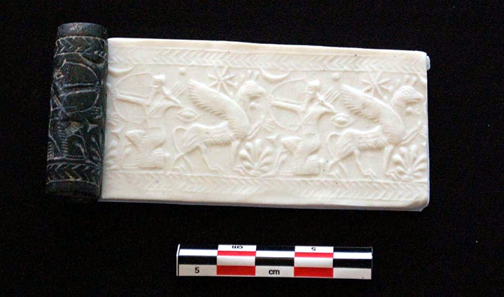 This cylinder seal dates back around 2,600 years, to a time after the Assyrians had re-conquered Idu. The seal, which originally may have been from a palace, would show a mythical scene if it was rolled on a piece of clay (reconstructed here in this image). It depicts a crouched bowman, who may be the god Ninurta, facing a griffon. A lunar crescent (representing the moon god), an eight-pointed morning star (representing the goddess Ishtar) and a palmette are all readily seen. © Image credit: Courtesy Cinzia Pappi