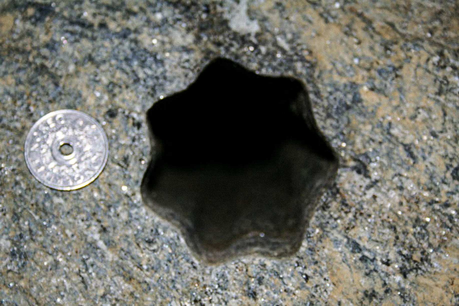 This star-shaped hole (with seven sides) was found by contractors on Friday November 30, 2007 in Volda, Norway.the Norwegian 5 - kroner coin is 25 mm in diameter. The hole is approx 65 - 70 mm in diameter.