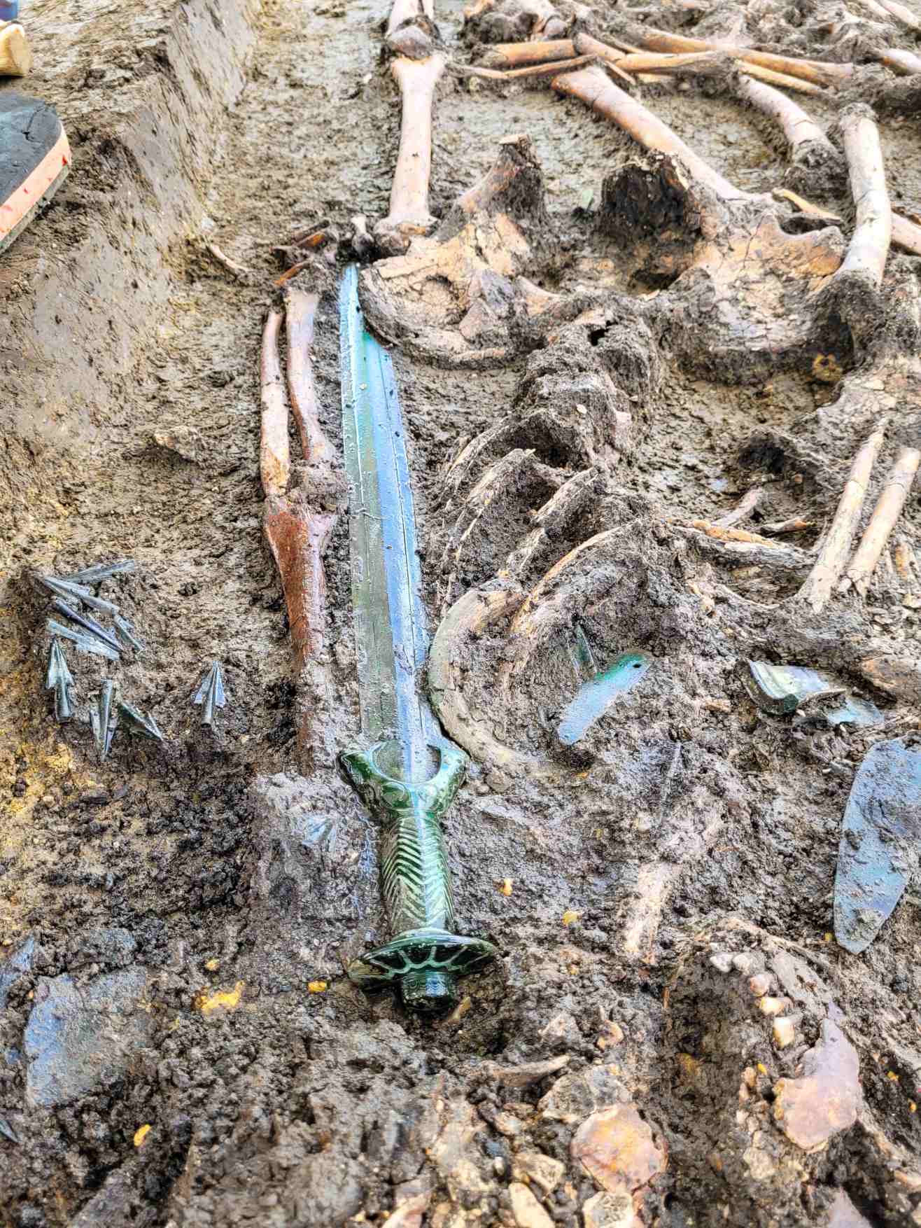 The newfound sword was discovered in a burial that had the remains of a man, woman and child.